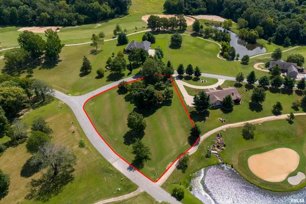 an aerial view of a house with yard swimming pool and outdoor seating