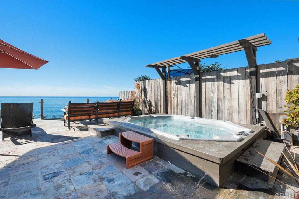 378 Neptune Avenue Encinitas, CA 92024 - Photo 12 of 45 a backyard of a house with barbeque oven table and chairs