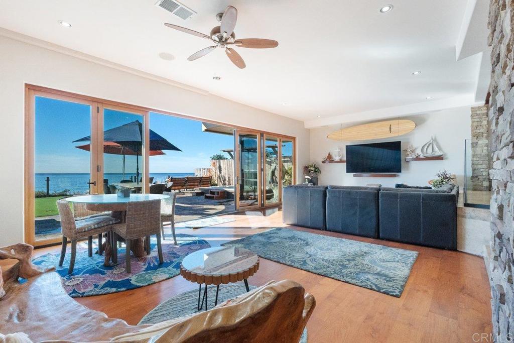 378 Neptune Avenue Encinitas, CA 92024 - Photo 13 of 45 a living room with furniture a flat screen tv and a table