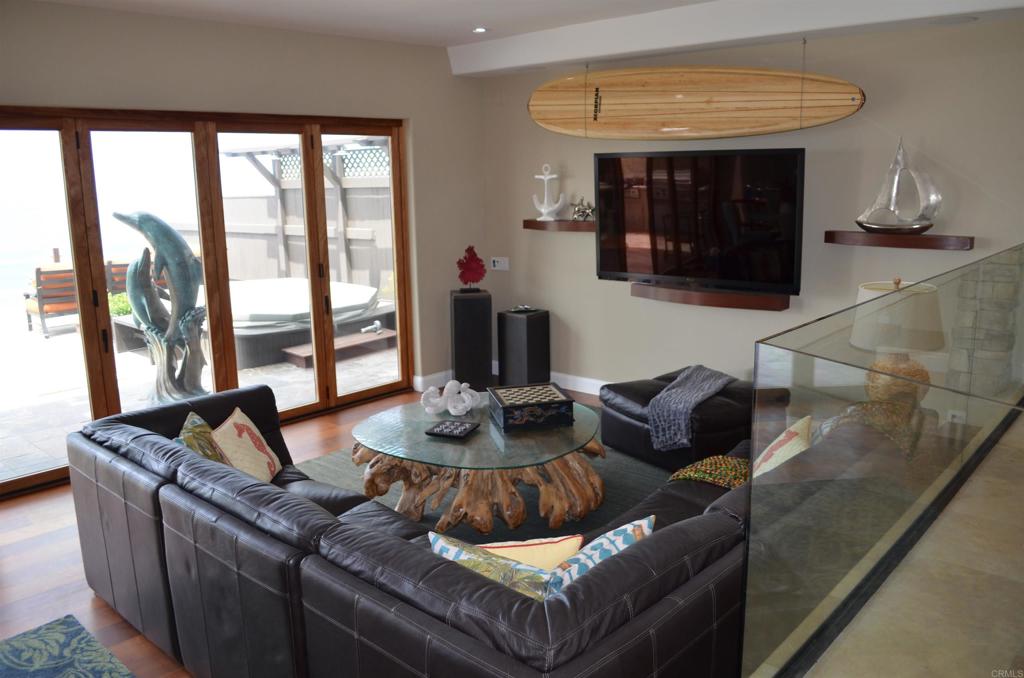 378 Neptune Avenue Encinitas, CA 92024 - Photo 17 of 45 a living room with furniture and a fireplace