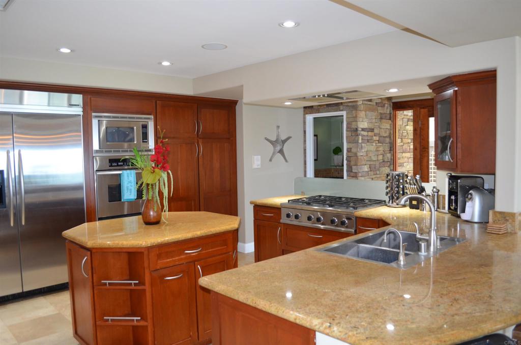 378 Neptune Avenue Encinitas, CA 92024 - Photo 19 of 45 a kitchen with stainless steel appliances granite countertop a sink a stove and a refrigerator