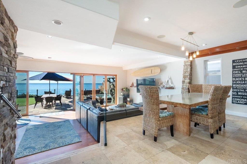 378 Neptune Avenue Encinitas, CA 92024 - Photo 28 of 45 a dining room with furniture and a floor to ceiling window