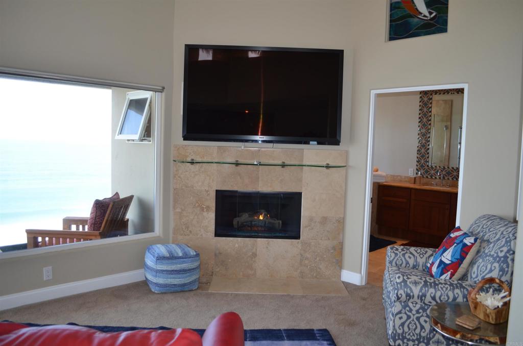 378 Neptune Avenue Encinitas, CA 92024 - Photo 29 of 45 a living room with furniture and a fireplace