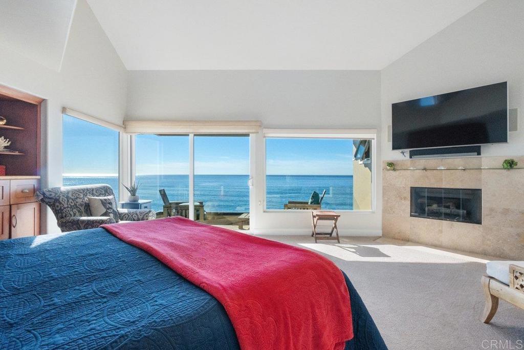 378 Neptune Avenue Encinitas, CA 92024 - Photo 31 of 45 a large bedroom with a bed and a flat screen tv