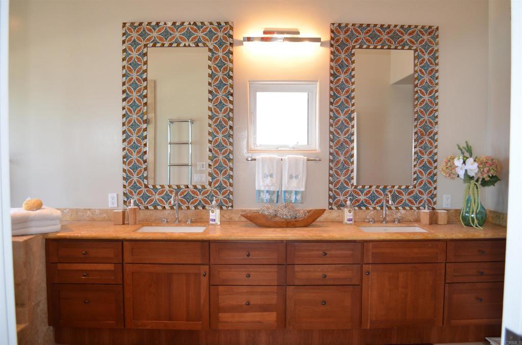 378 Neptune Avenue Encinitas, CA 92024 - Photo 33 of 45 a bathroom with a sink and a mirror