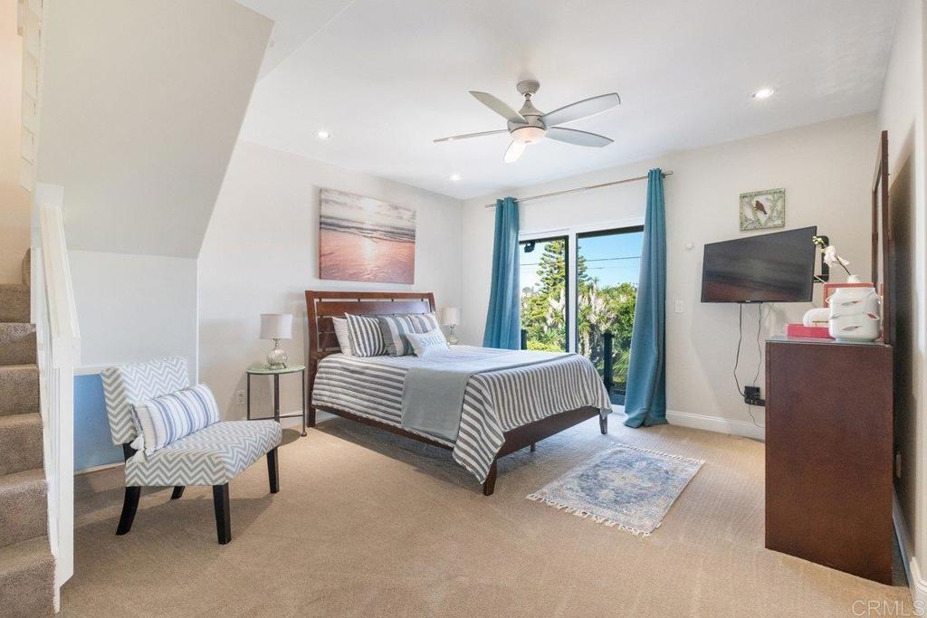 378 Neptune Avenue Encinitas, CA 92024 - Photo 36 of 45 a bedroom with a bed flat screen tv and a couch