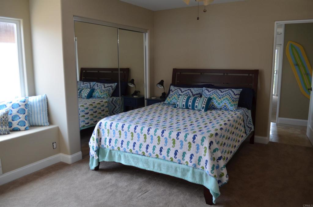 378 Neptune Avenue Encinitas, CA 92024 - Photo 37 of 45 a bedroom with a bed and a mirror on dresser