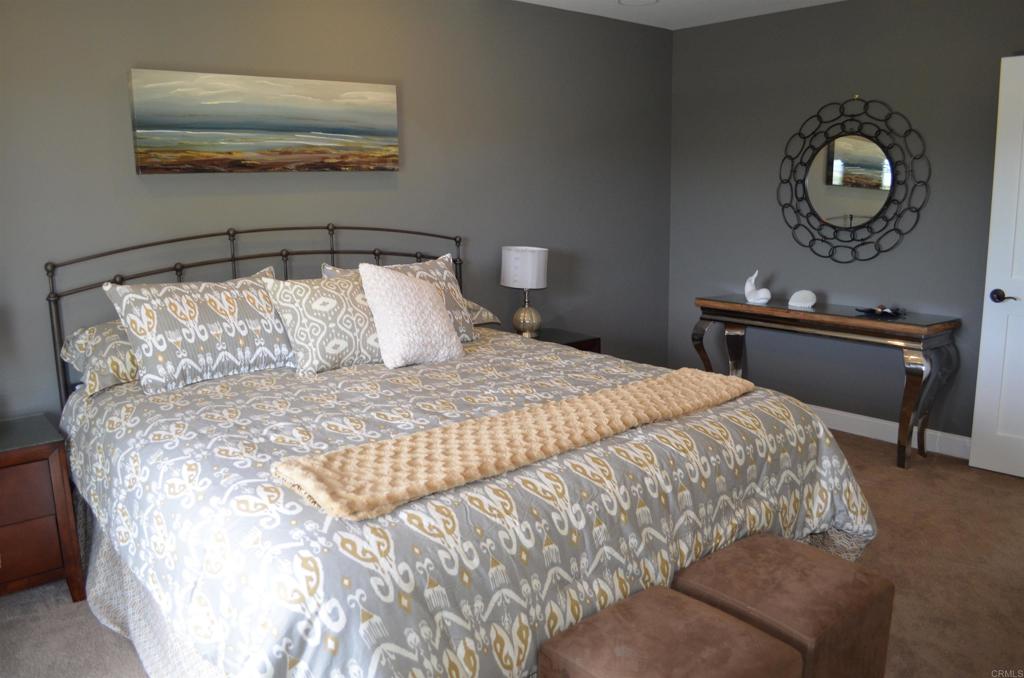 378 Neptune Avenue Encinitas, CA 92024 - Photo 40 of 45 a large bed sitting in a bedroom next to a lamp