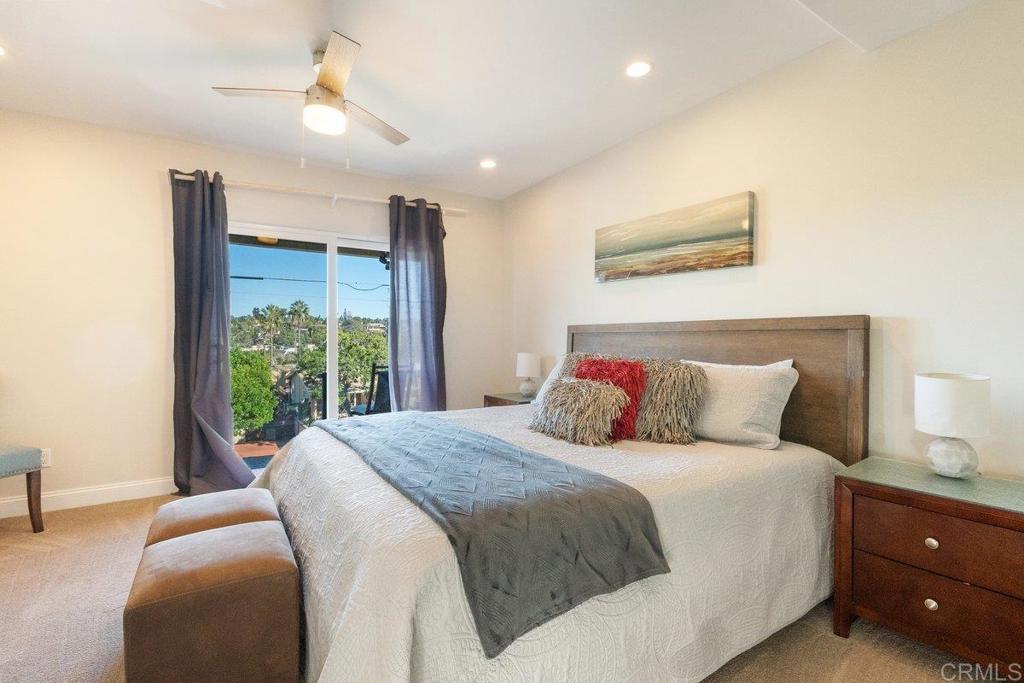 378 Neptune Avenue Encinitas, CA 92024 - Photo 42 of 45 a bedroom with a large bed and a chandelier