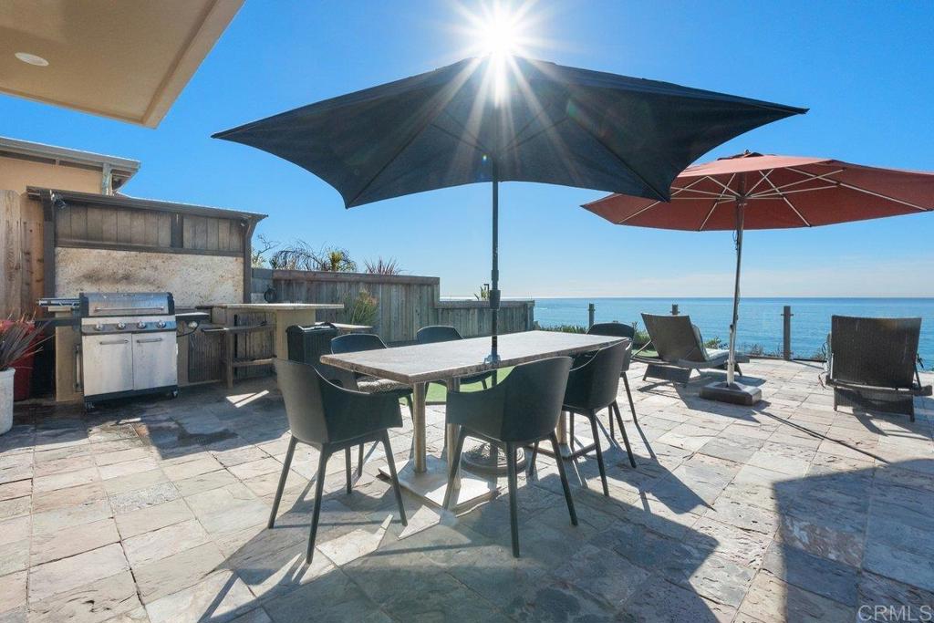 378 Neptune Avenue Encinitas, CA 92024 - Photo 9 of 45 a view of a dining table and chairs in the patio