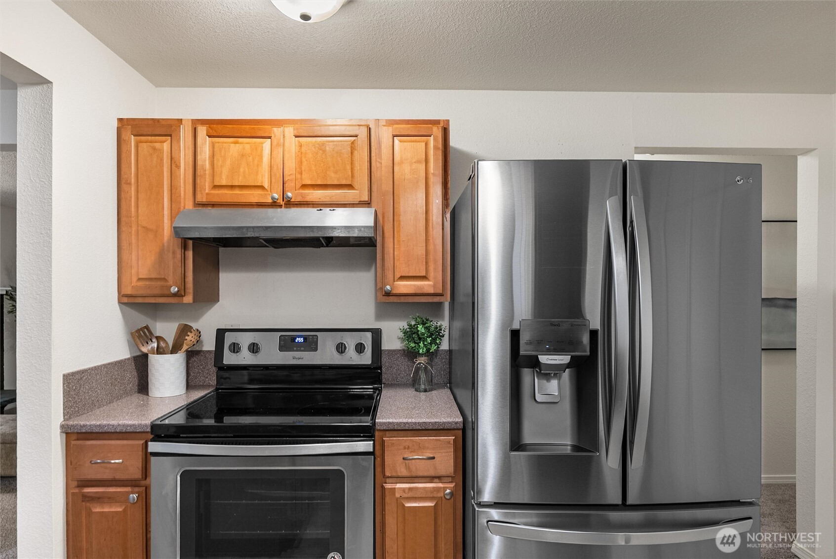 4785 Northwest Anderson Hill Road Silverdale, WA 98383 - Photo 12 of 38 a kitchen with a stove and a refrigerator