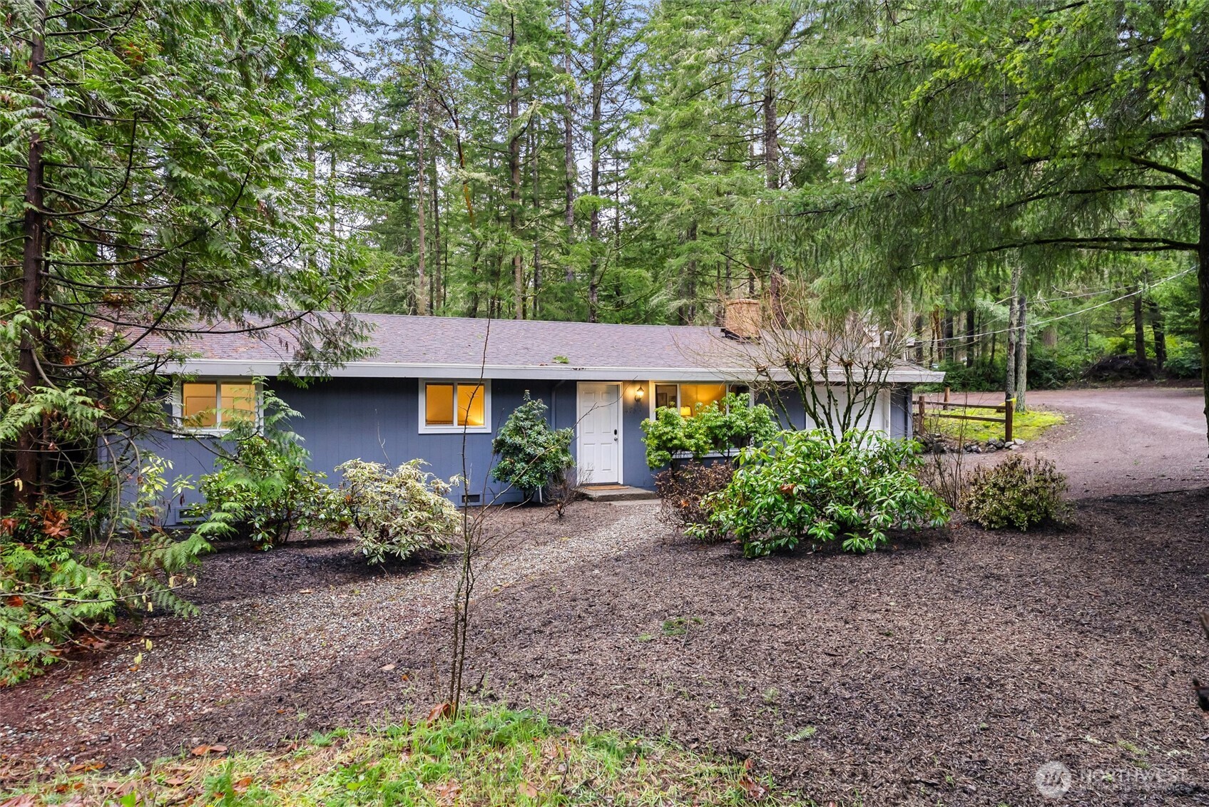 4785 Northwest Anderson Hill Road Silverdale, WA 98383 - Photo 2 of 38 a front view of a house with a yard and outdoor seating