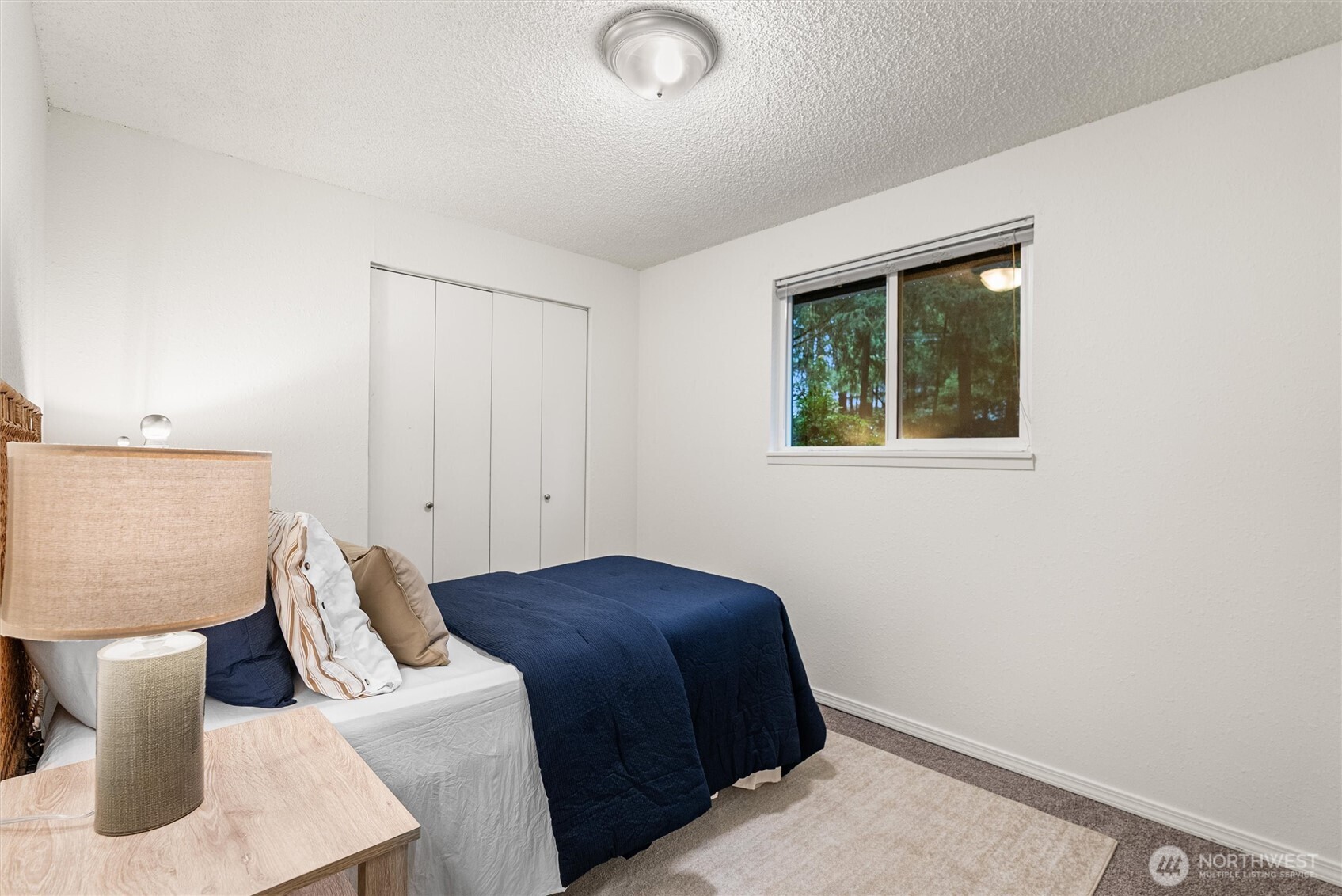 4785 Northwest Anderson Hill Road Silverdale, WA 98383 - Photo 21 of 38 a bedroom with a bed and a window