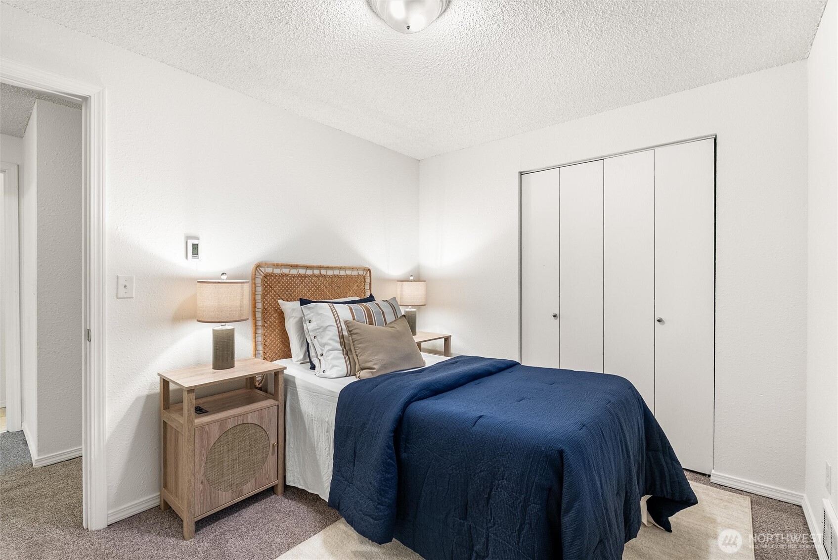4785 Northwest Anderson Hill Road Silverdale, WA 98383 - Photo 22 of 38 a bedroom with a bed and a lamp