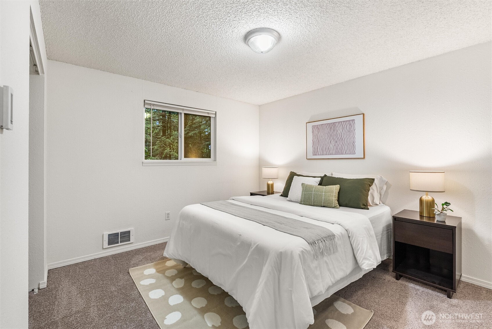 4785 Northwest Anderson Hill Road Silverdale, WA 98383 - Photo 24 of 38 a bedroom with a bed and a lamp