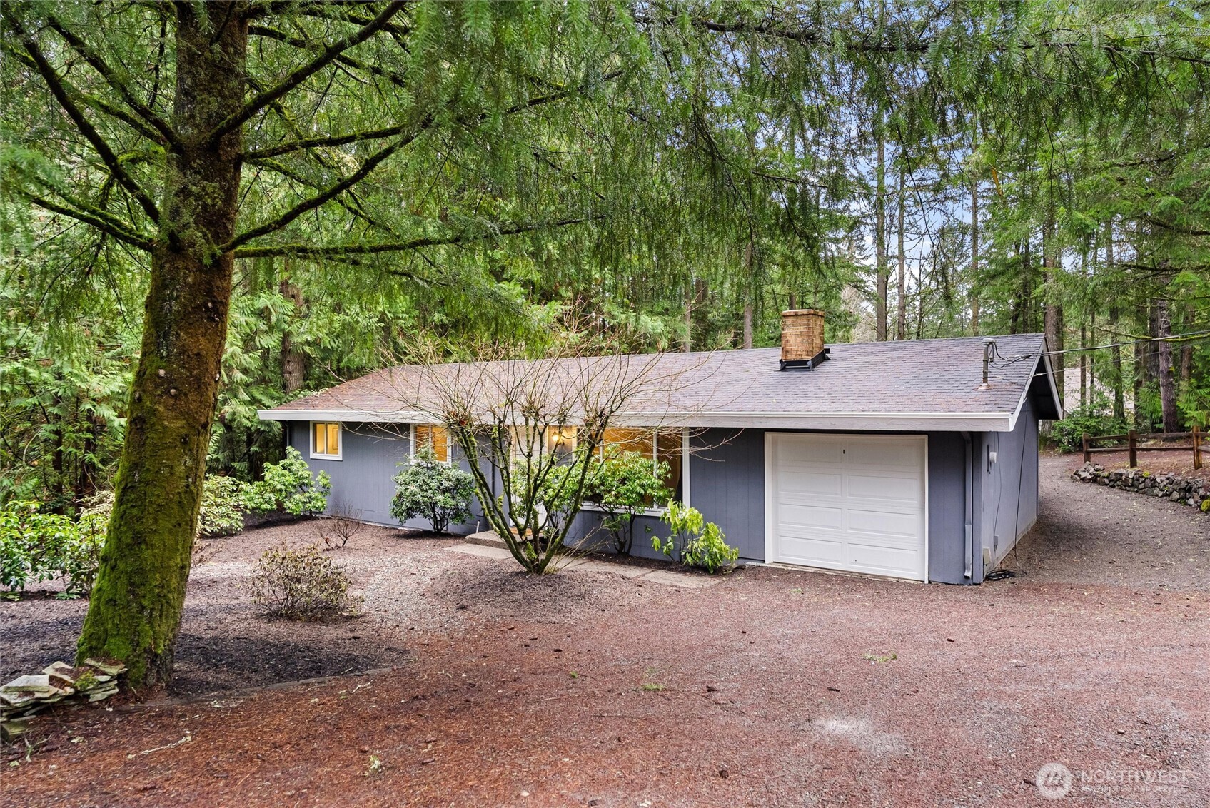 4785 Northwest Anderson Hill Road Silverdale, WA 98383 - Photo 4 of 38 a front view of a house with a yard and garage