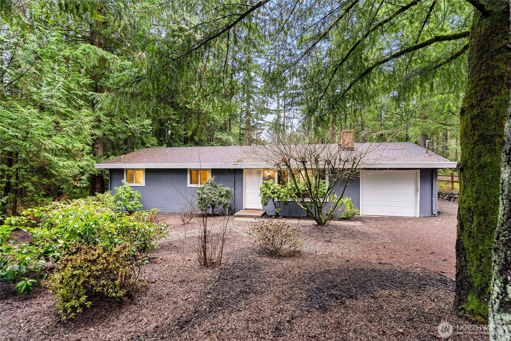 4785 Northwest Anderson Hill Road Silverdale, WA 98383 - Photo 5 of 38 a front view of a house with a garden
