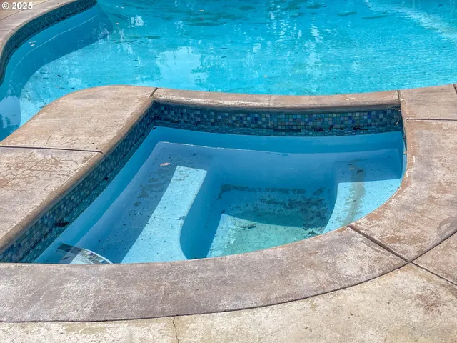 a swimming pool with outdoor seating and yard
