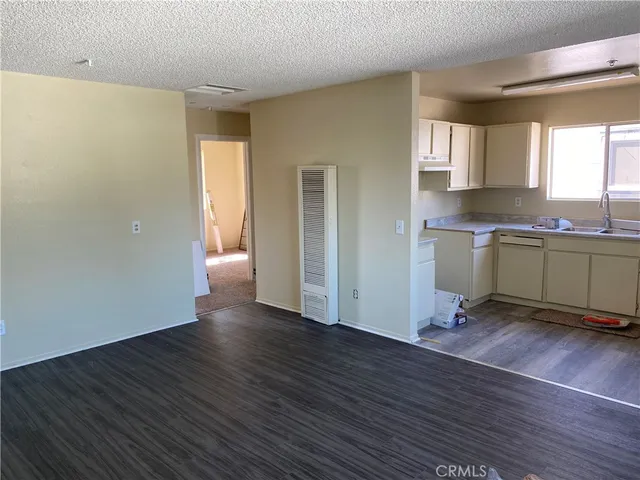 a view of a kitchen with wooden floor and a sink