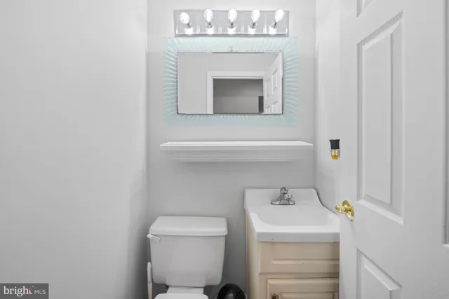 a view of a hallway and a livingroom with furniture