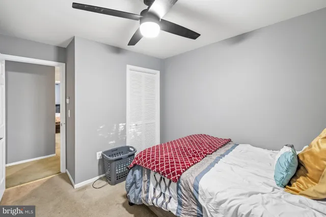 a bedroom with furniture a bed and a chandelier