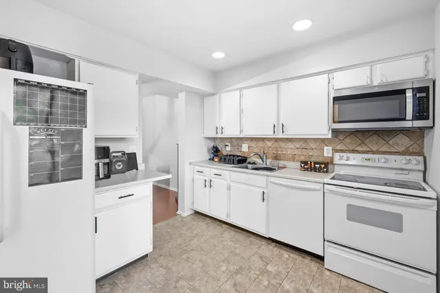 a kitchen with stainless steel appliances a refrigerator and a stove top oven