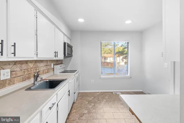 a view of a dining room with furniture wooden floor and a chandelier
