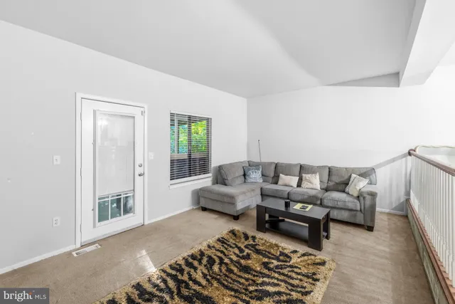 a living room with furniture and a rug