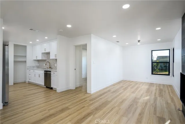 a view of kitchen with wooden floor and electronic appliances