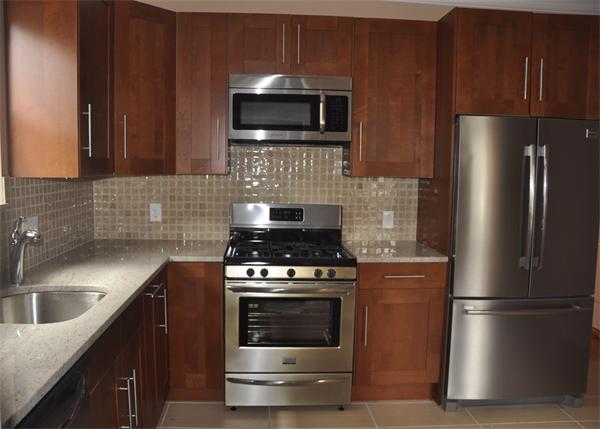 9 Washburn Terrace, Unit 2 Brookline, MA 02446 - Photo 3 of 9 a kitchen with a stove microwave and refrigerator