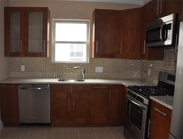 9 Washburn Terrace, Unit 2 Brookline, MA 02446 - Photo 4 of 9 a kitchen with stainless steel appliances a sink stove and microwave