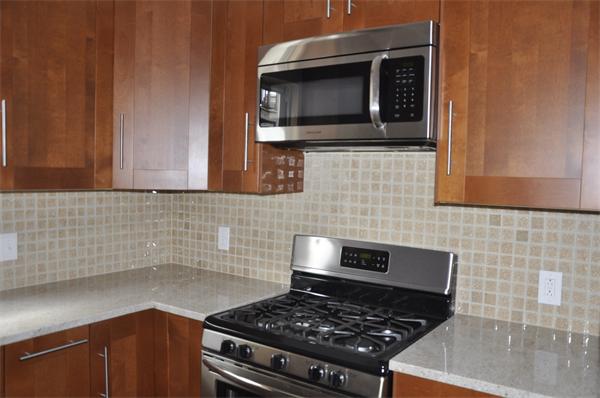 9 Washburn Terrace, Unit 2 Brookline, MA 02446 - Photo 5 of 9 a kitchen with a stove and a microwave