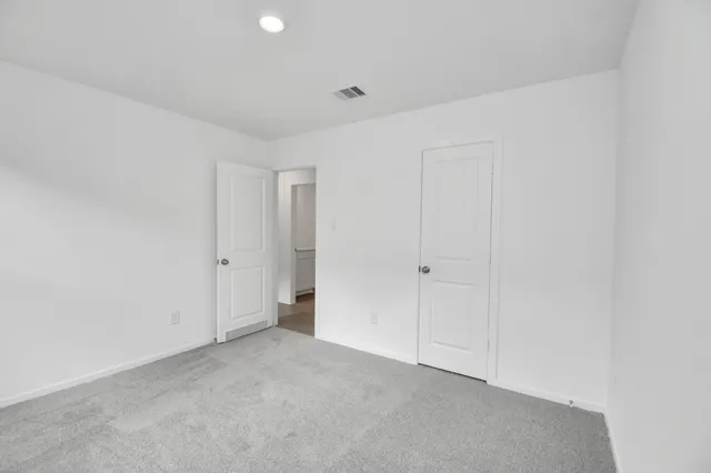 a view of a backyard with barn plants and large tree