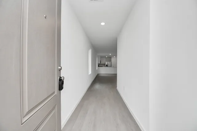 a view of a hallway with a white walls