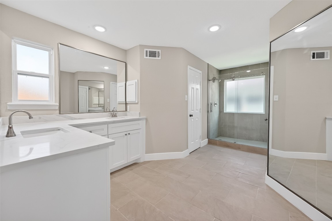 2318 Irish Spring Drive Houston, TX 77067 - Photo 14 of 25 a bathroom with a shower sink and mirror
