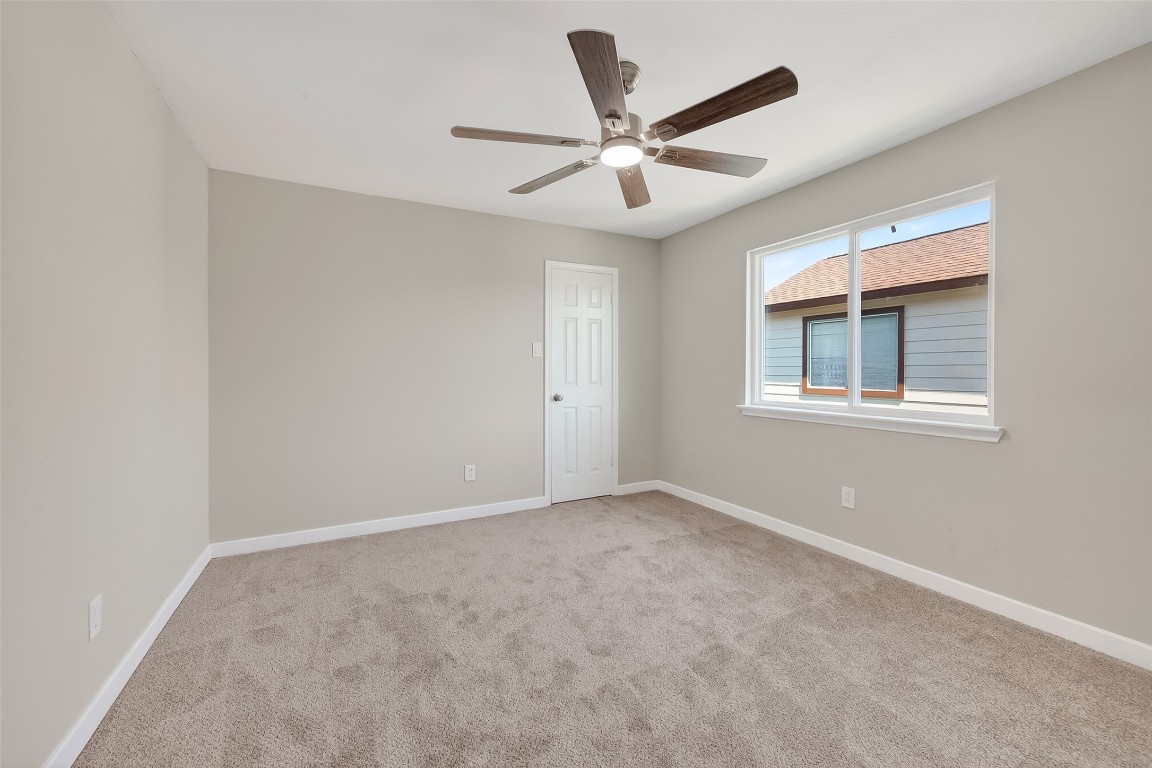 2318 Irish Spring Drive Houston, TX 77067 - Photo 22 of 25 an empty room with window and ceiling fan