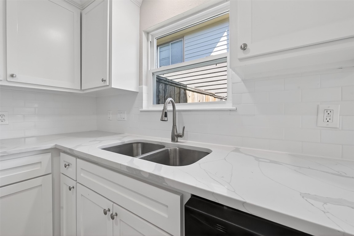 2318 Irish Spring Drive Houston, TX 77067 - Photo 9 of 25 a kitchen with a sink and cabinets