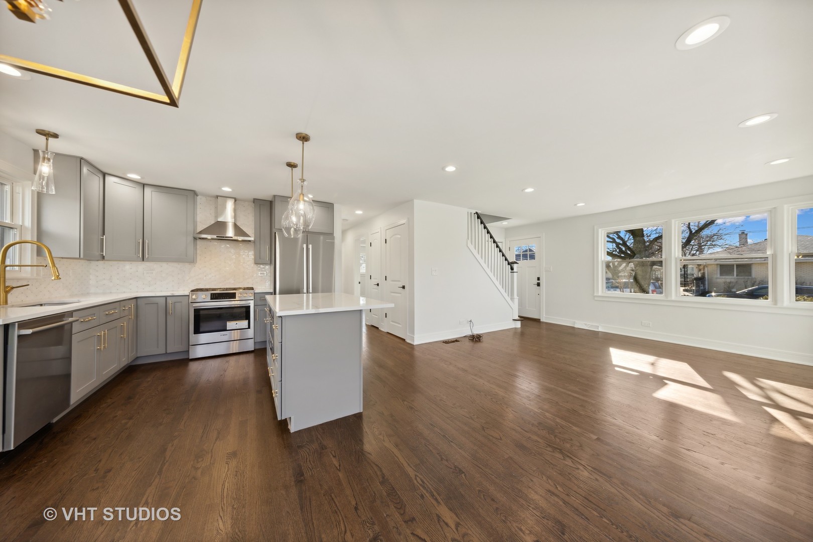 771 Swain Avenue Elmhurst, IL 60126 - Photo 11 of 43 a large kitchen with a wooden floor and stainless steel appliances