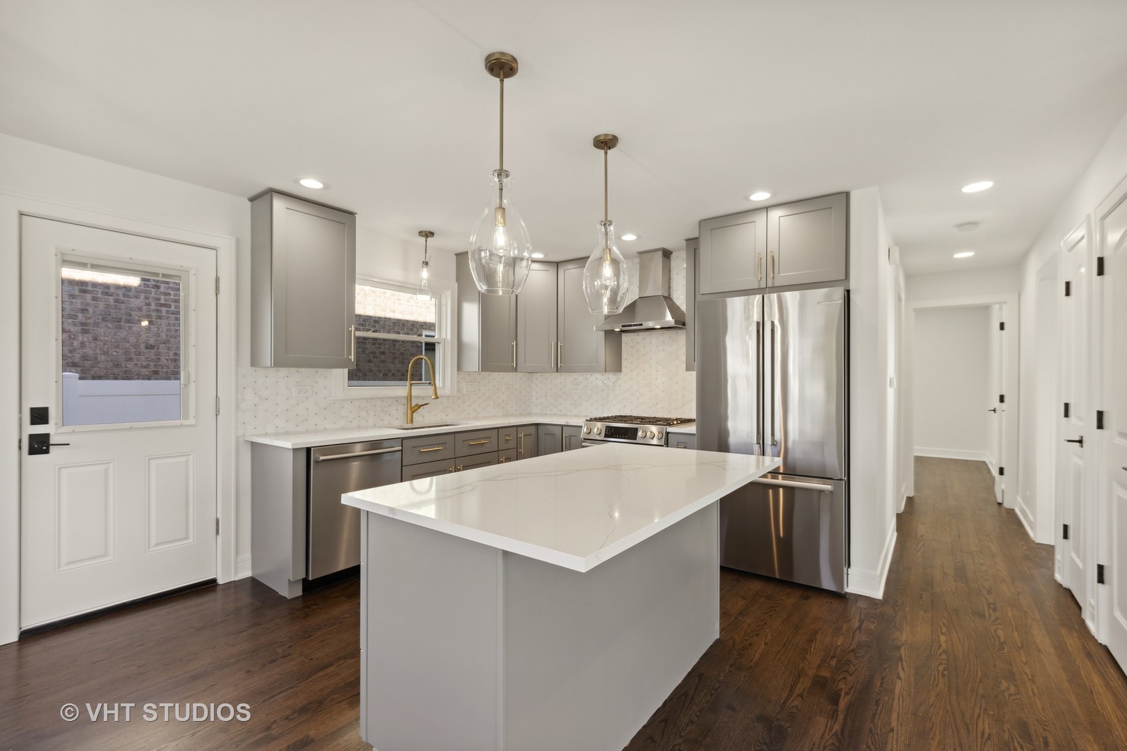 771 Swain Avenue Elmhurst, IL 60126 - Photo 14 of 43 a large kitchen with stainless steel appliances a refrigerator a sink and wooden floors