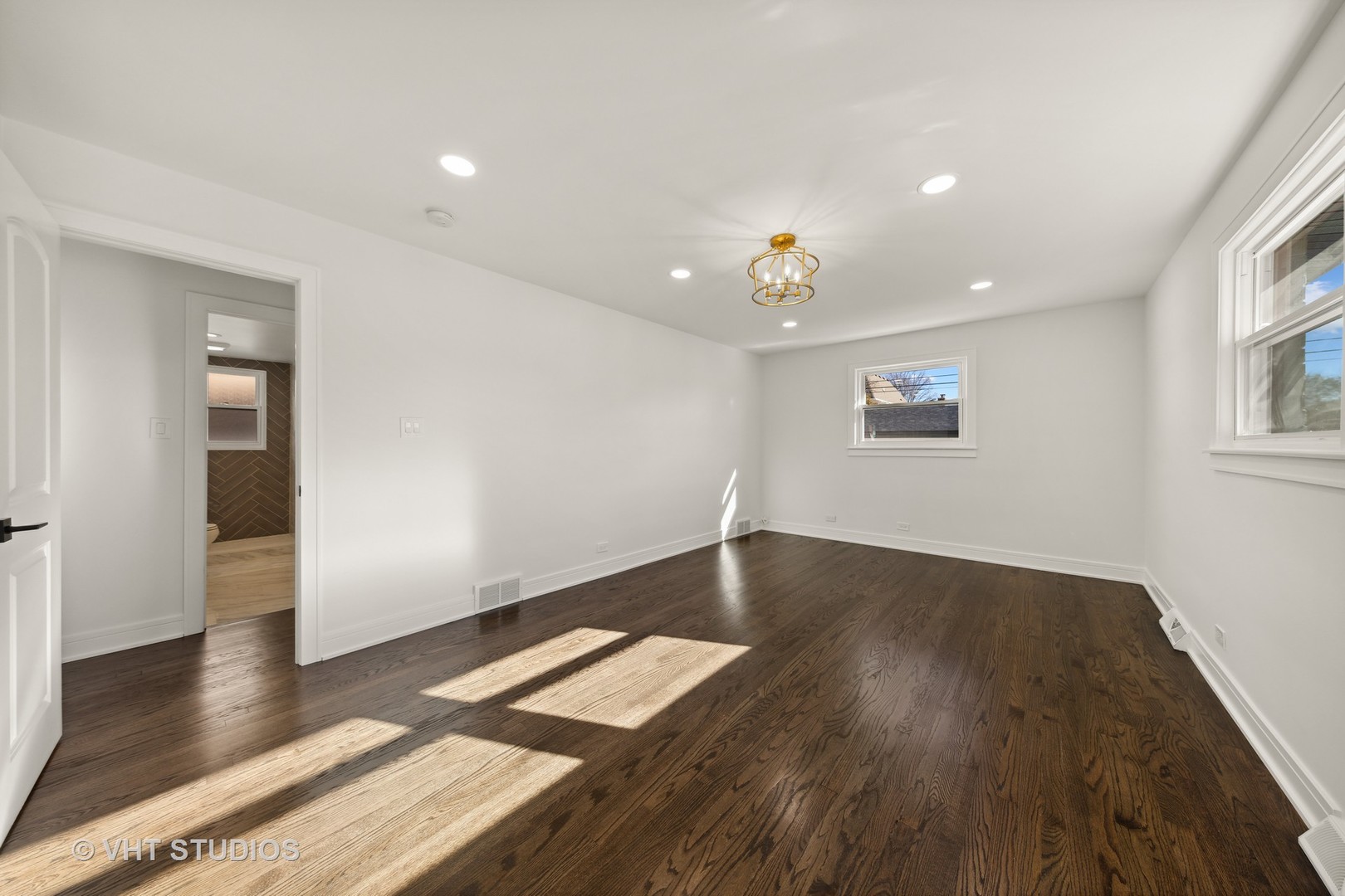 771 Swain Avenue Elmhurst, IL 60126 - Photo 21 of 43 an empty room with wooden floor and windows