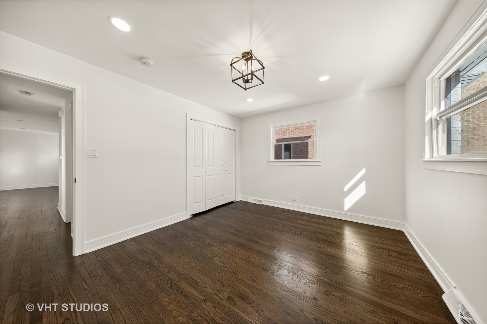 771 Swain Avenue Elmhurst, IL 60126 - Photo 26 of 43 a view of an empty room with wooden floor and a window