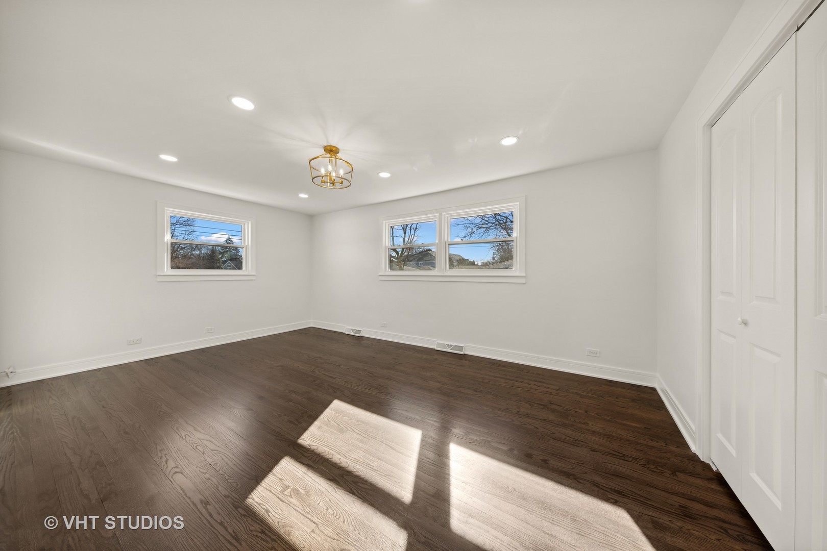 771 Swain Avenue Elmhurst, IL 60126 - Photo 28 of 43 a view of a big room with wooden floor and windows