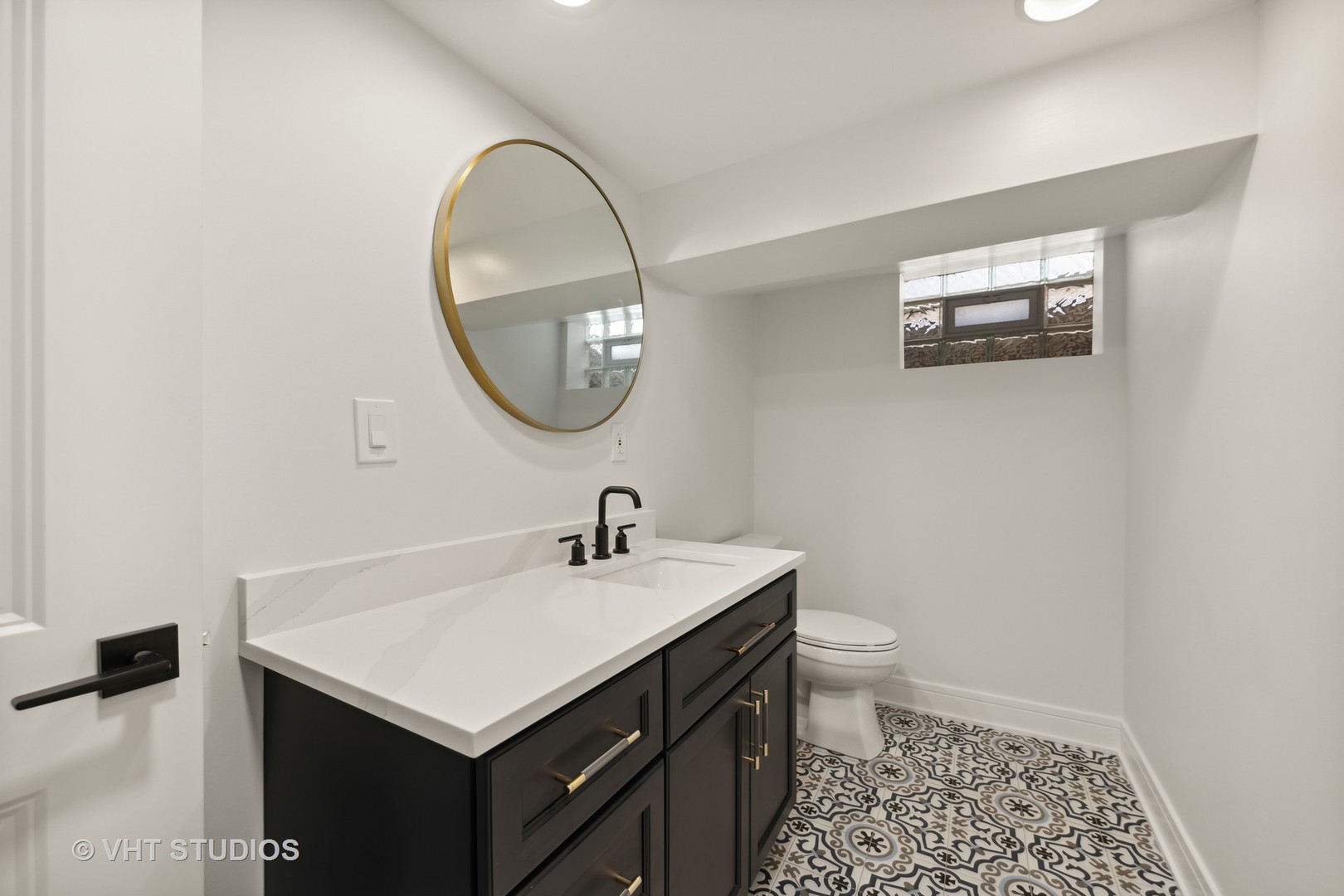 771 Swain Avenue Elmhurst, IL 60126 - Photo 35 of 43 a bathroom with a sink a toilet and a mirror