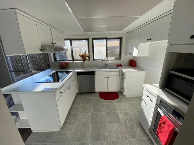 a room with a sink a washer and dryer