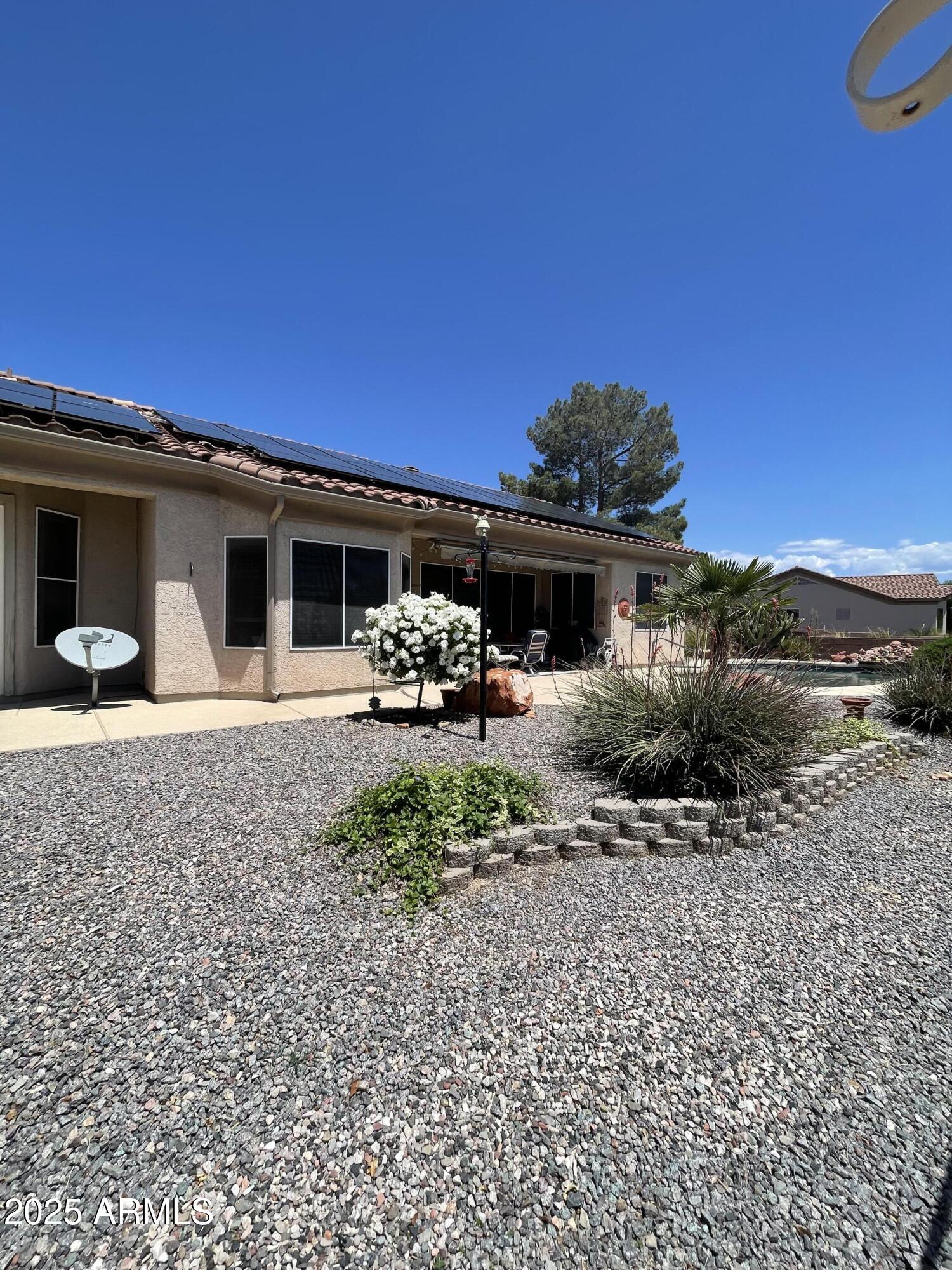 5325 Whisper Ridge Cornville, AZ 86325 - Photo 3 of 54 a front view of a house with a garden and yard