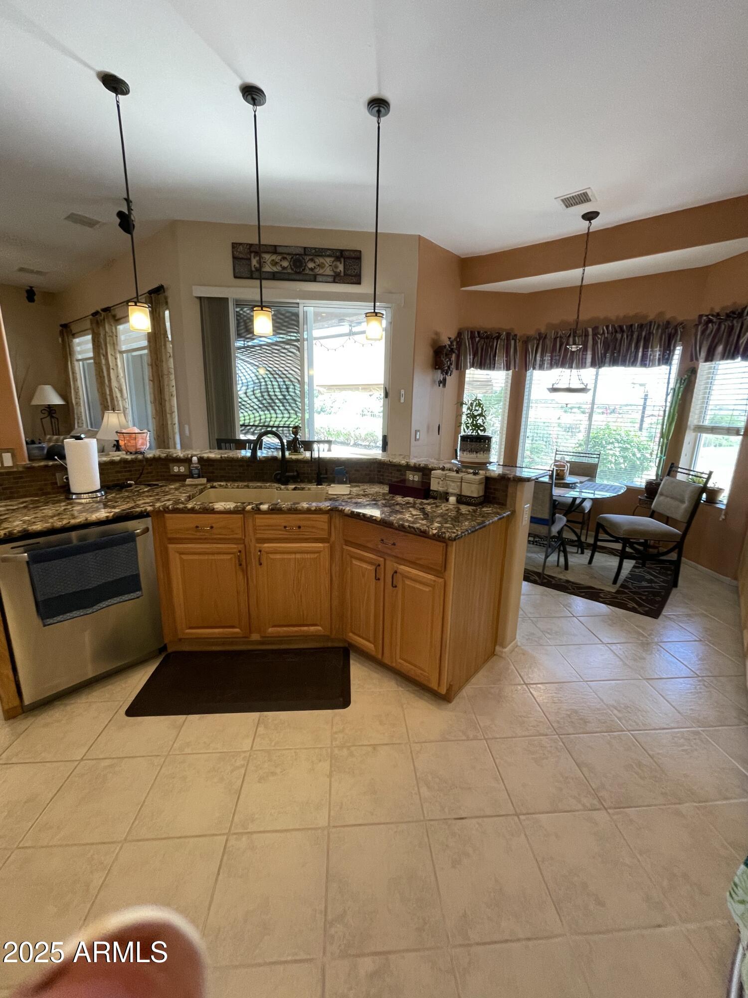 5325 Whisper Ridge Cornville, AZ 86325 - Photo 32 of 54 a kitchen with stainless steel appliances granite countertop a stove a sink a oven a dining table and chairs
