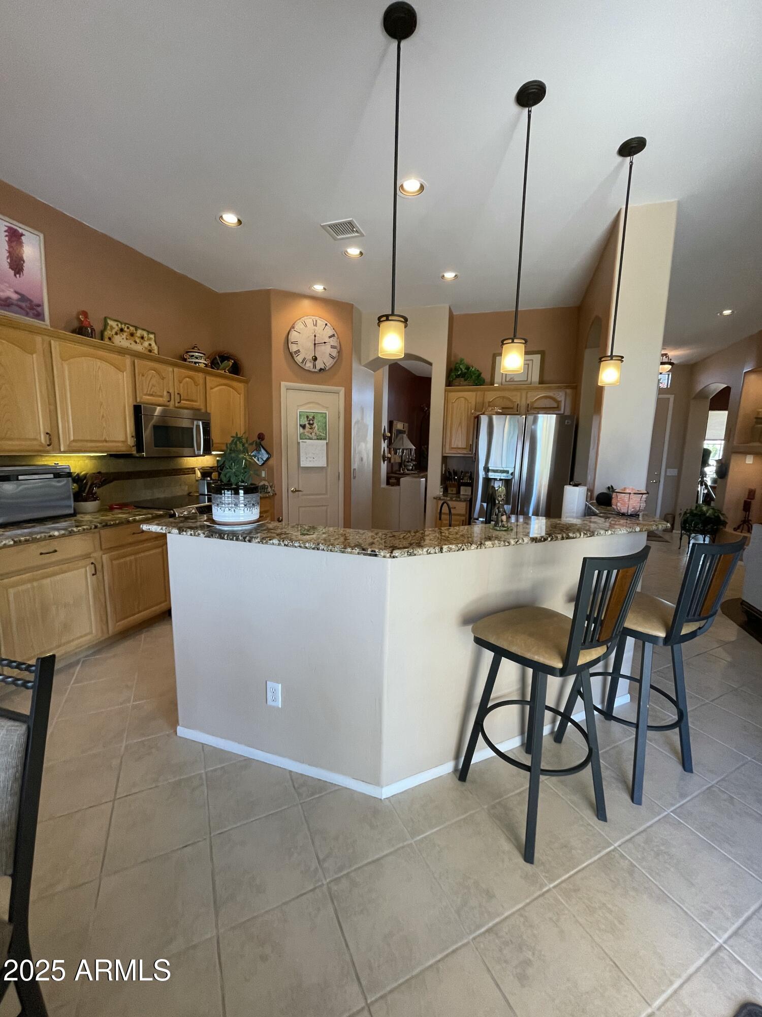 5325 Whisper Ridge Cornville, AZ 86325 - Photo 33 of 54 a kitchen with stainless steel appliances kitchen island granite countertop a sink a counter top space and cabinets