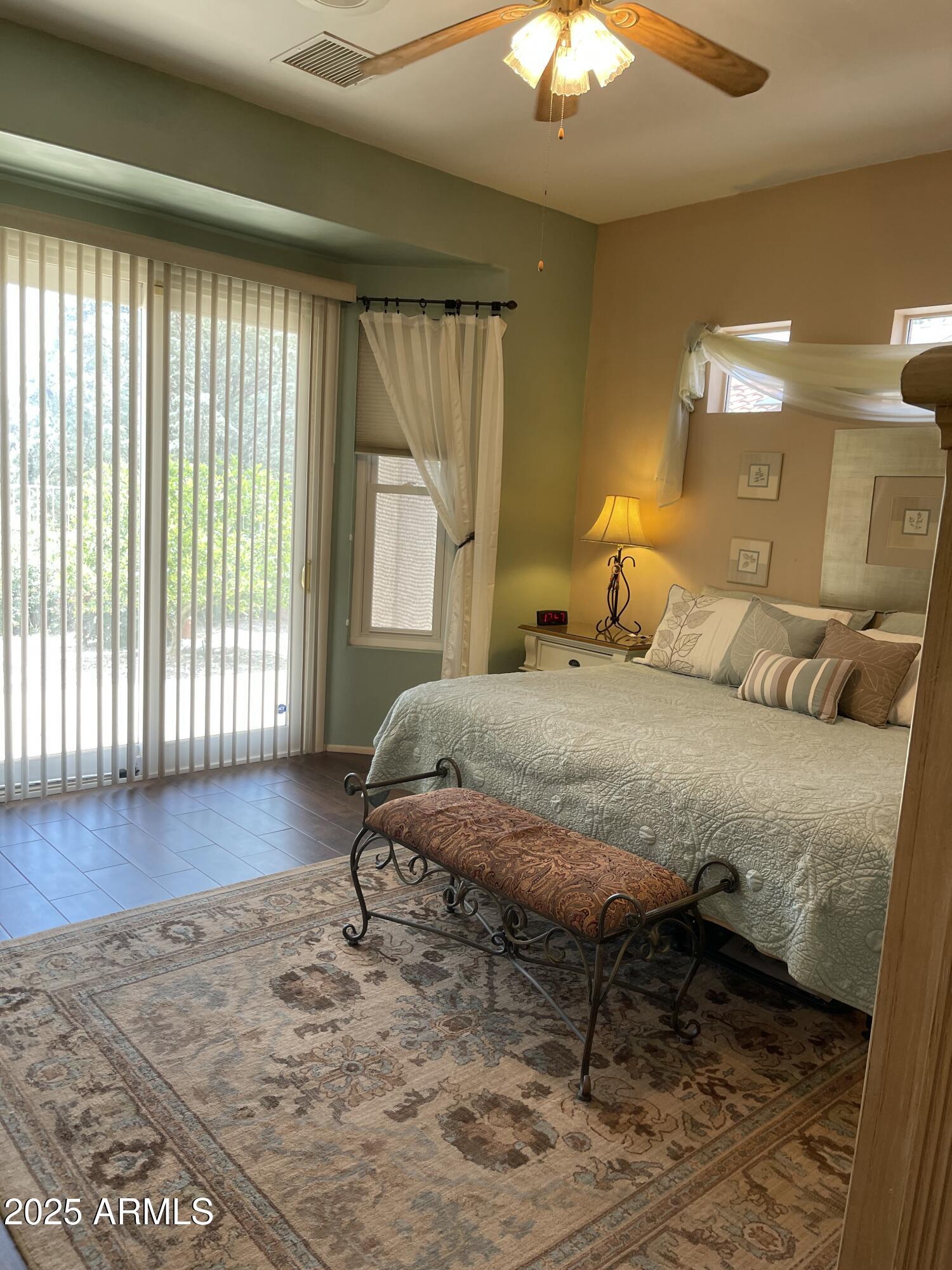 5325 Whisper Ridge Cornville, AZ 86325 - Photo 42 of 54 a bedroom with a bed wooden floor and window