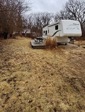 a backyard of a house with table and chairs