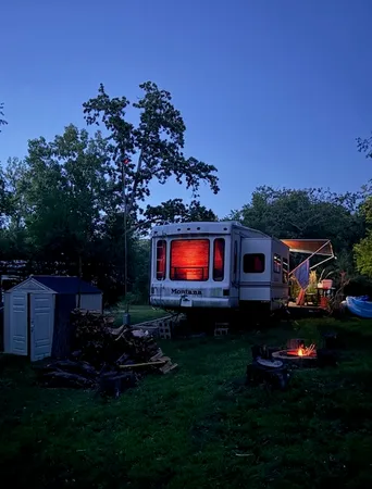 a backyard of a house with lots of green space and outdoor seating